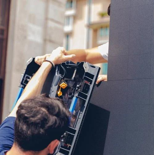 Technicians assembling LED display screen panels for event rental on-site