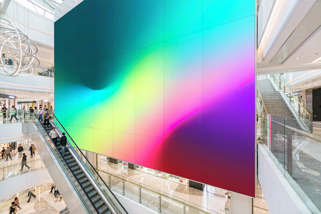 Seamless LED video wall panels installed in a shopping mall atrium, delivering vivid visuals for commercial displays
