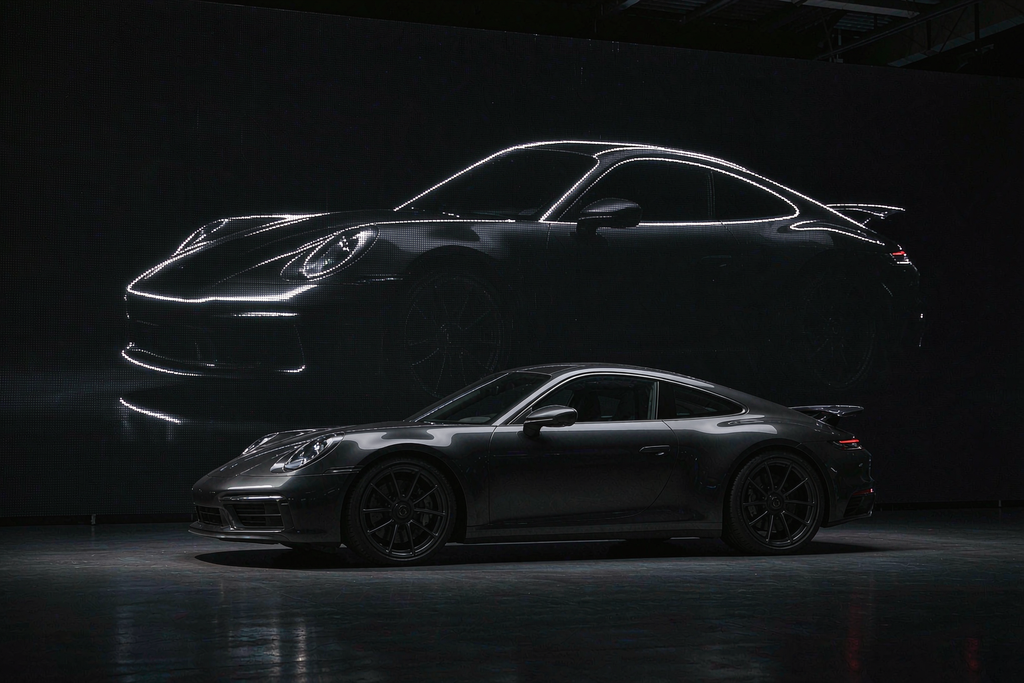 Luxury automotive showroom with a micro LED screen delivering perfect blacks and infinite contrast behind a sports car