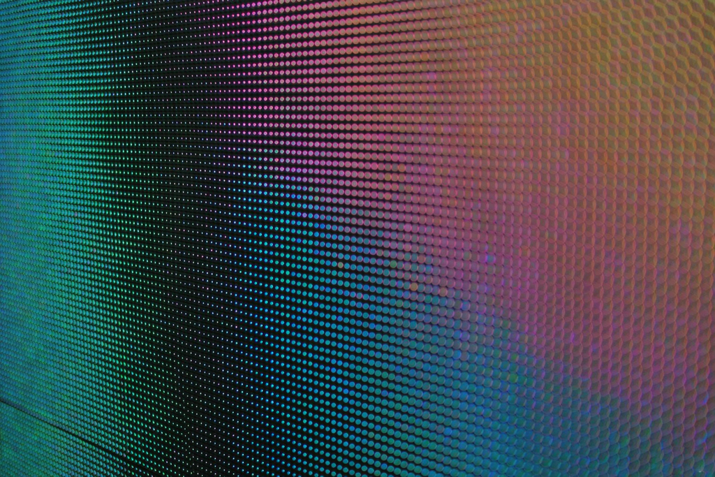 Close-up of church LED wall panel surface showing nearly invisible seams between modules with no black bezel lines