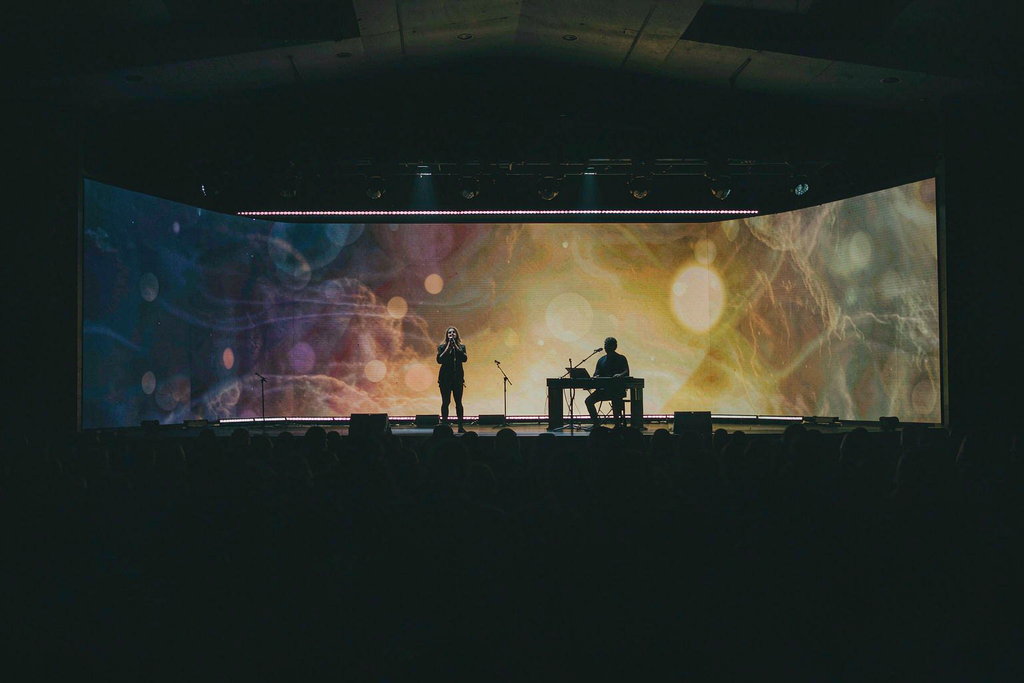 Ultra-wide seamless church LED screen showing one continuous worship visual with no bezel lines