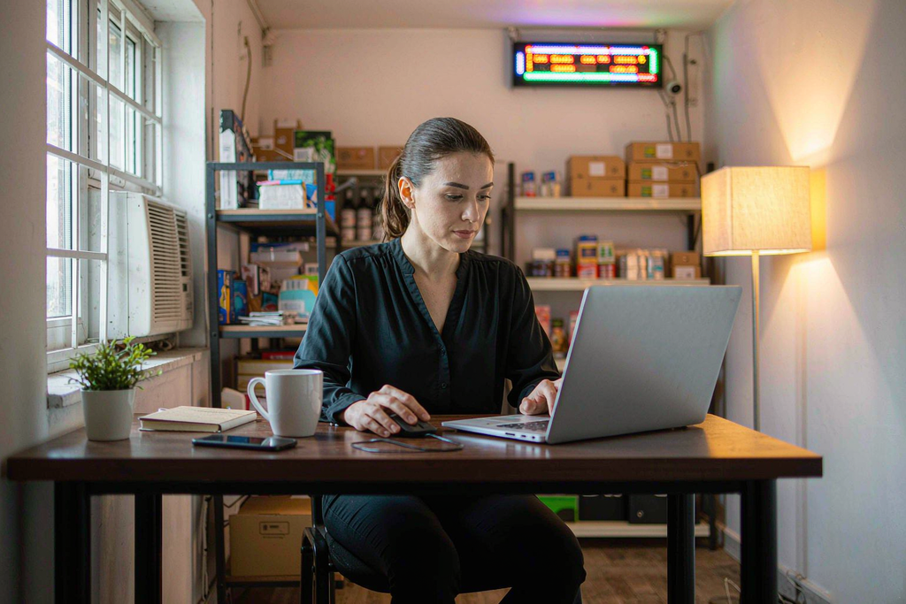 Shop manager scheduling LED scrolling sign content from a laptop in the store back office